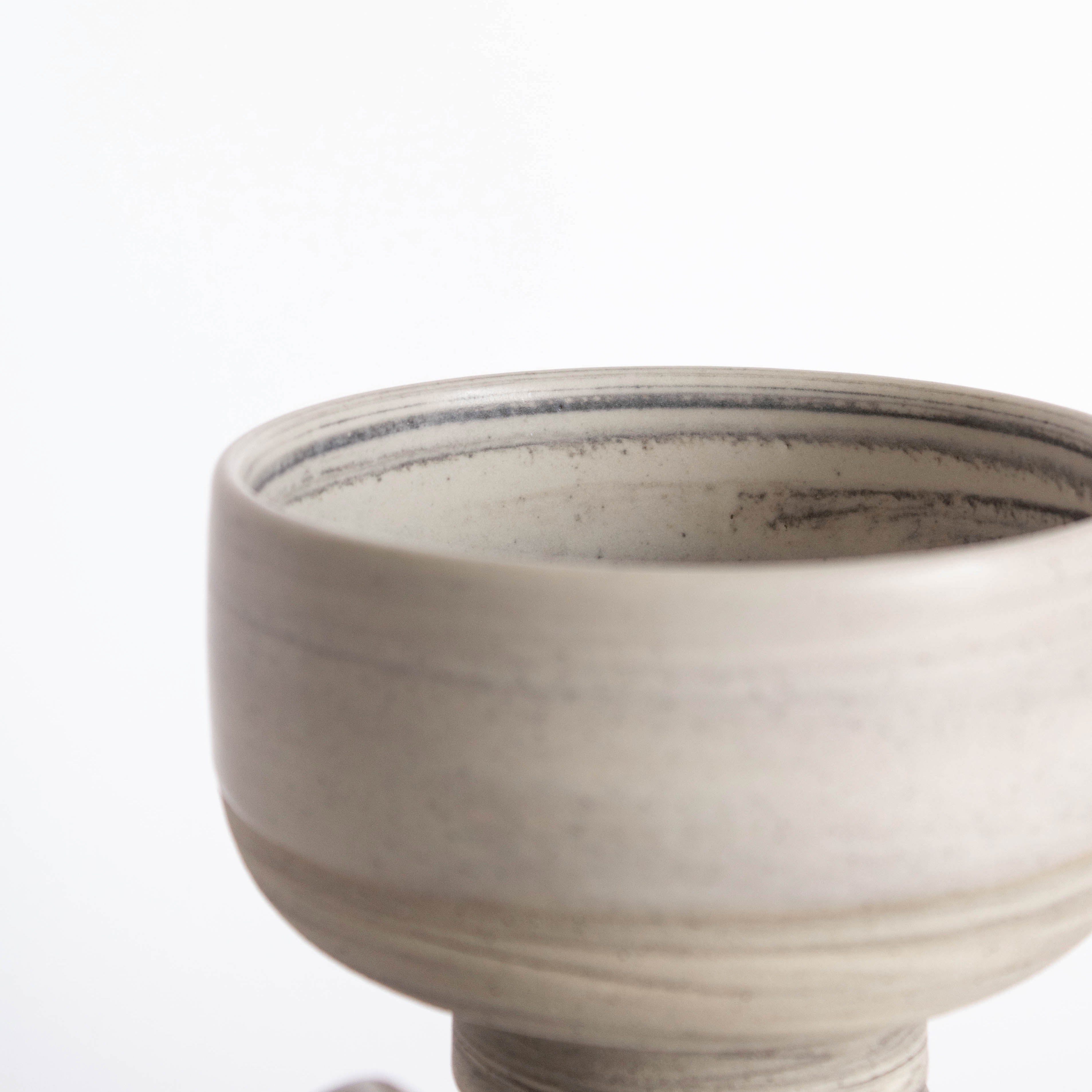 Close-up of the interior of a handmade ice cream bowl in earthy tones. 