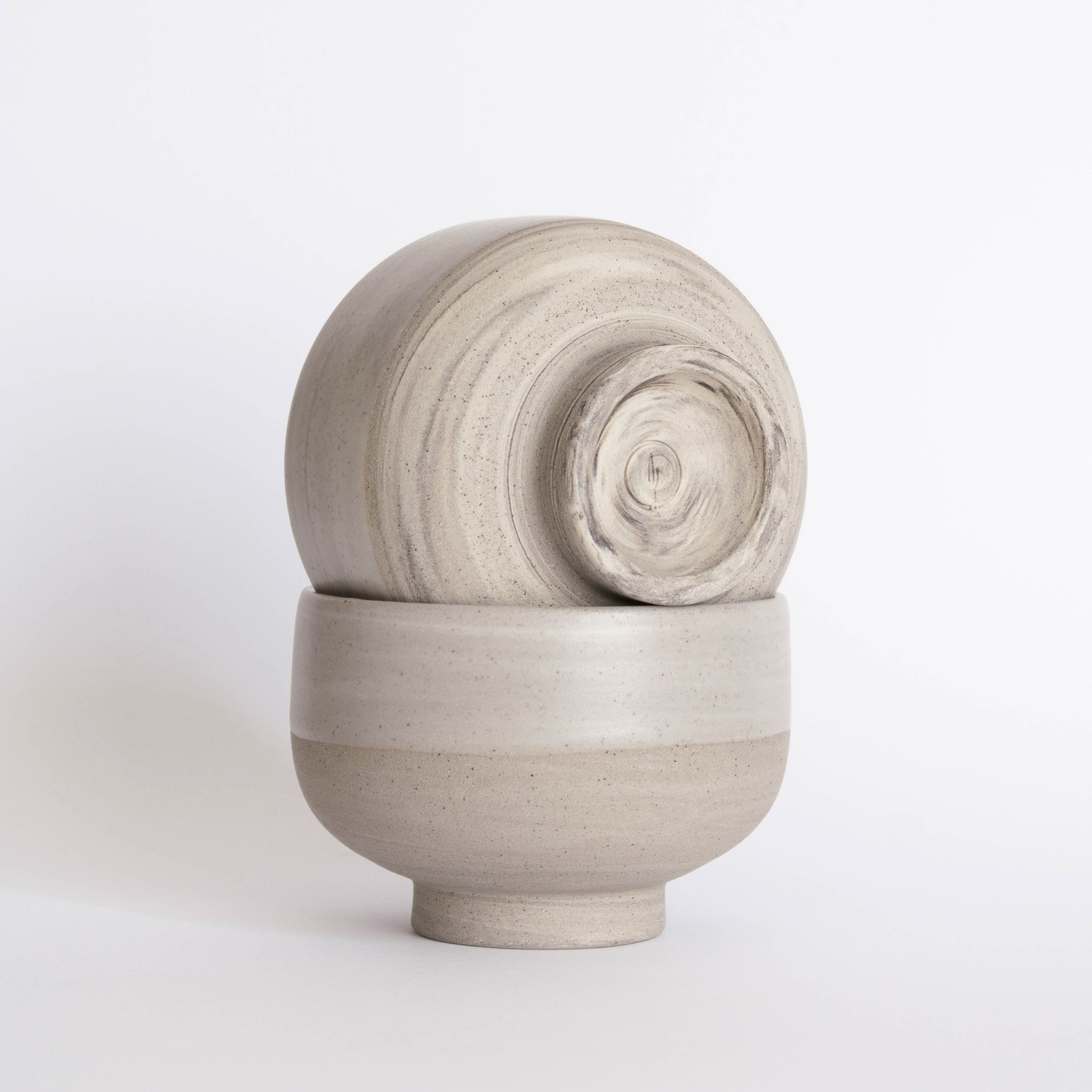 A pair of handmade earthy ice cream bowls against a white background.