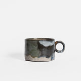 Ceramic mug with a textured surface on a white background