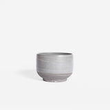 Handmade cappuccino cup featuring a matte marble finish in natural earthy hues, set against a white background.